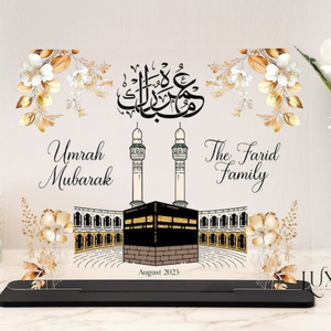 Custom Umrah Mubarak Acrylic Plaque featuring a beautiful Kaaba design, gold floral accents, and Arabic calligraphy, personalized with family names and date—perfect for Islamic gifts, Umrah return keepsakes, and special celebrations.