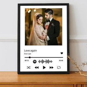 Customizable lyrical keepsake frame with a wedding photo and "Love Again" by Dua Lipa, featuring a Spotify waveform, displayed on a wooden surface