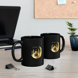 Pair of Ramadan Moon and Mosque Mugs with a golden crescent moon and mosque silhouette design, placed on a desk with office accessories.