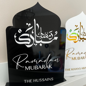 Personalized Ramadan Acrylic Sign with black background featuring Arabic calligraphy and "Ramadan Mubarak" in golden letters, customized with family name "The Hussains."