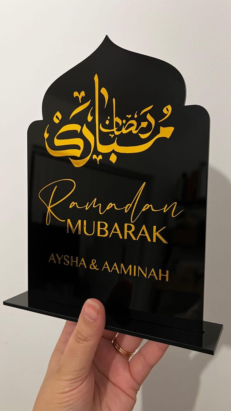 Personalized Ramadan Acrylic Sign featuring Arabic calligraphy with "Ramadan Mubarak" in gold letters, customized with family names "Aysha & Aaminah."