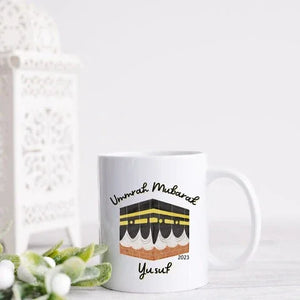 Personalized Umrah Mubarak mug with the Kaaba design and the name “Yusuf,” perfect for celebrating Umrah completion in 2023.