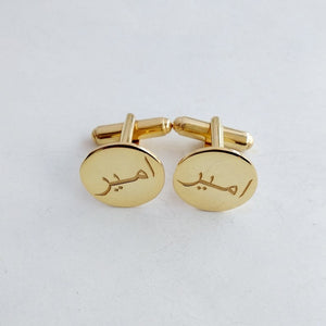 Personalized gold cufflinks with the Arabic name "Ameer engraved, displayed on a white background