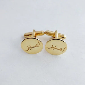 Personalized gold cufflinks with the Arabic name "Ameer engraved, displayed on a white background