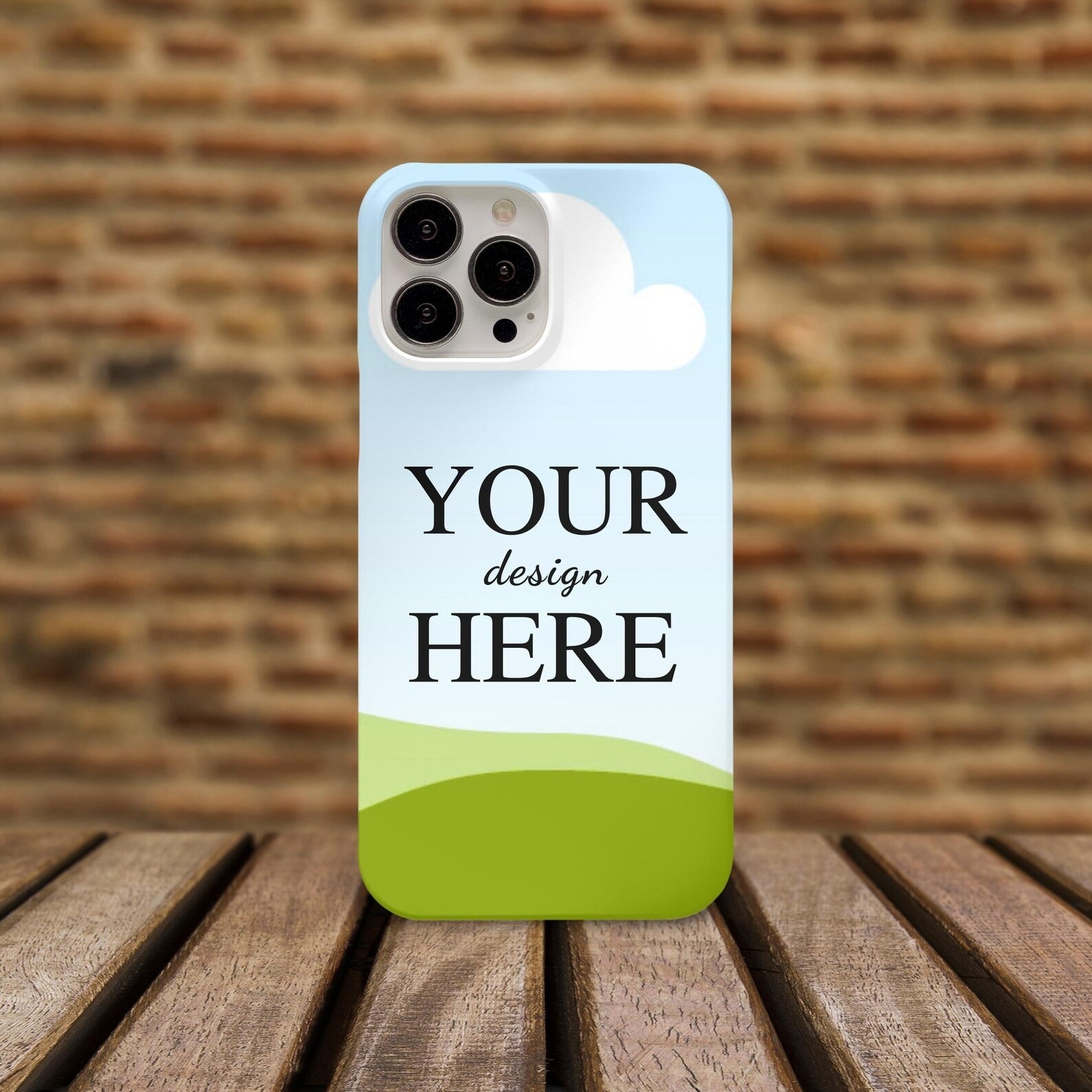 Personalized mobile cover placed on a wooden surface with a rustic brick wall background, perfect for showcasing unique designs.