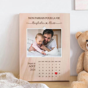 Personalized engraved wooden frame with a photo, calendar, and custom names, designed as a meaningful gift for a baptism or special occasion.