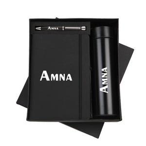 Personalized black gift set with custom-engraved notebook, pen, and thermos bottle in a premium gift box.
