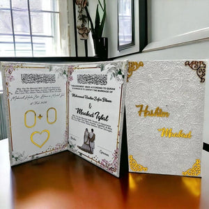 A beautifully designed white and gold Nikah certificate book with intricate floral embossing and gold corner details. Personalized with the names "Hashim & Maabad" in gold script, featuring an elegant interior layout for signatures and thumbprints.