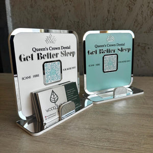 A professional Queen’s Crown Dental QR Code Display in white and light blue, featuring a business card holder for easy access to digital services.