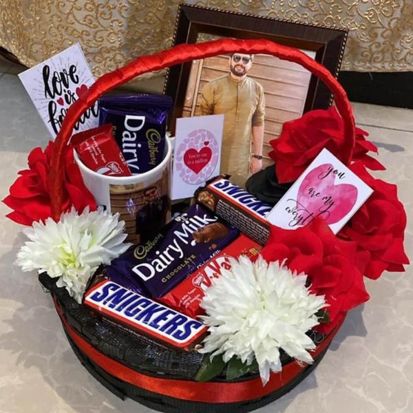 Floral Chocolate Basket with Dairy Milk, Snickers, flowers, and photo frame