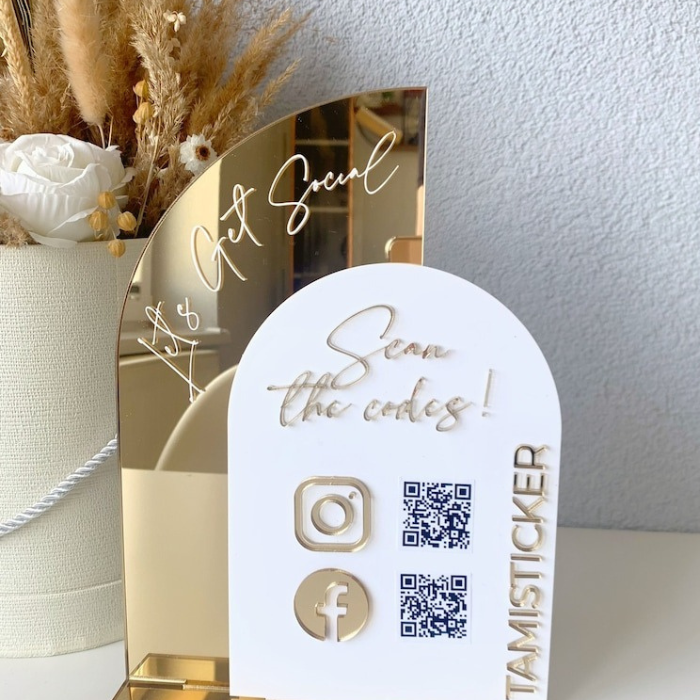 Elegant gold-accented acrylic QR code sign featuring Instagram, Facebook, and scannable QR codes for social media engagement, designed for businesses like salons, cafes, and boutiques.