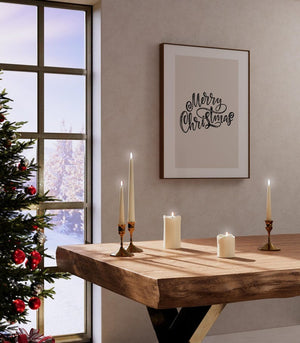 Framed 'Merry Christmas' wall art print styled with festive candles and a rustic table, creating a cozy holiday setting