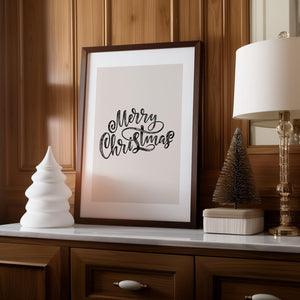 Christmas typography framed print with 'Merry Christmas' displayed on a wooden shelf, styled with festive home decorations.