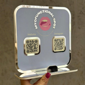 Light blue QR code sign for Myofunctional Spot, displaying website and Instagram links for easy access.