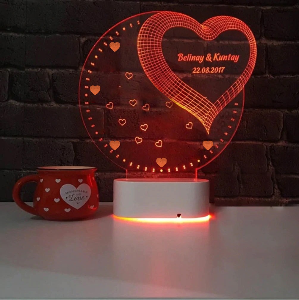 Personalized 3D Illusion LED Lamp glowing with heart and names beside a love mug
