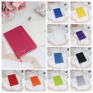 Set of three personalized notebooks in black, blue, and pink, featuring custom name engravings.