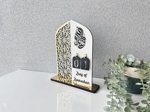 Ramadan table decor featuring elegant Islamic centerpiece with crescent moon and lantern design, warm LED lighting, festive Ramadan home decoration.