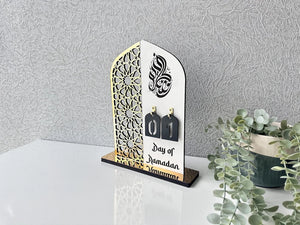 Ramadan table decor featuring elegant Islamic centerpiece with crescent moon and lantern design, warm LED lighting, festive Ramadan home decoration.