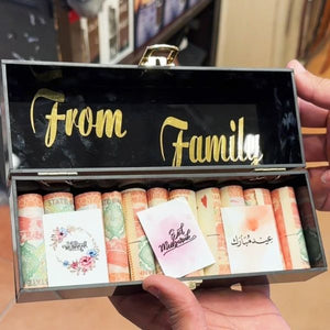 Closeup of Special Customized Eidi Box with artificial flowers and "Happy Eid" tag