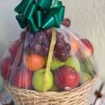 Fresh fruit basket with green bow, perfect for gifting in Gujranwala
