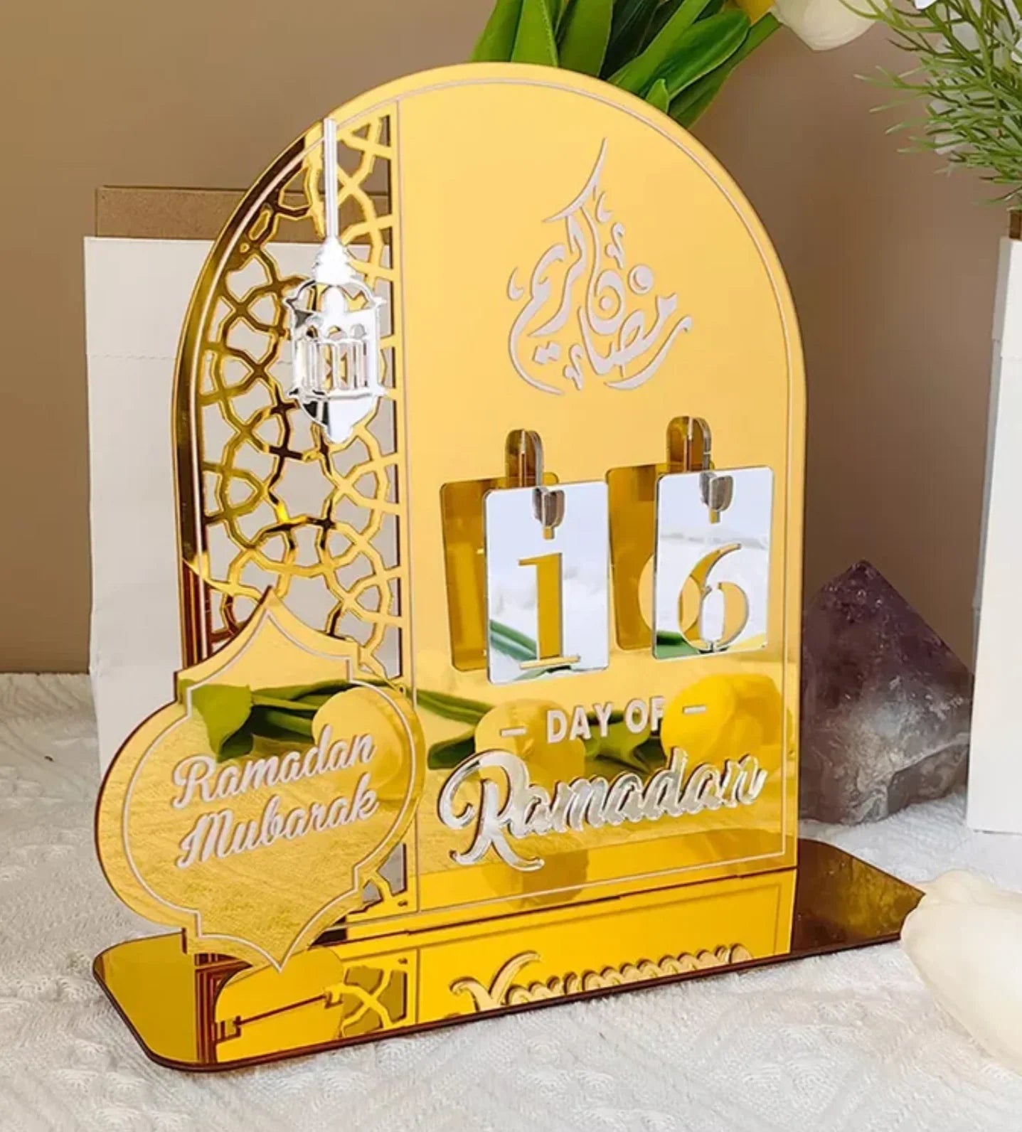 Golden Ramadan countdown calendar with 'Ramadan Mubarak' and Arabic calligraphy, decorative lantern design