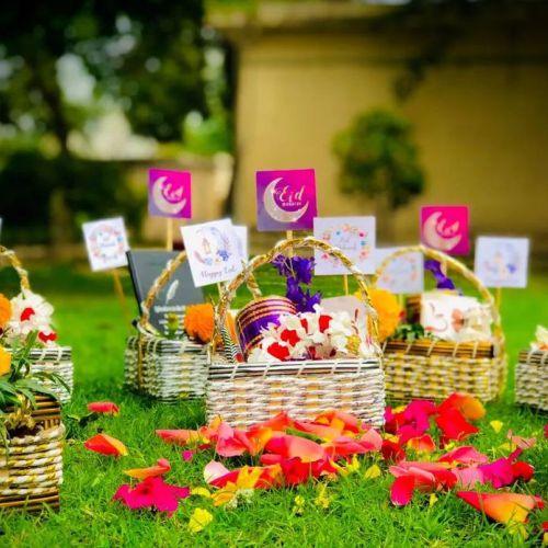 Eid gift baskets with floral decorations and Eid cards on grass, perfect for celebrations
