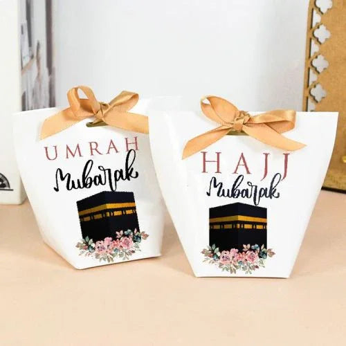 Umrah Mubarak and Hajj Mubarak gift boxes with Kaaba design and floral accents, perfect for religious celebrations.