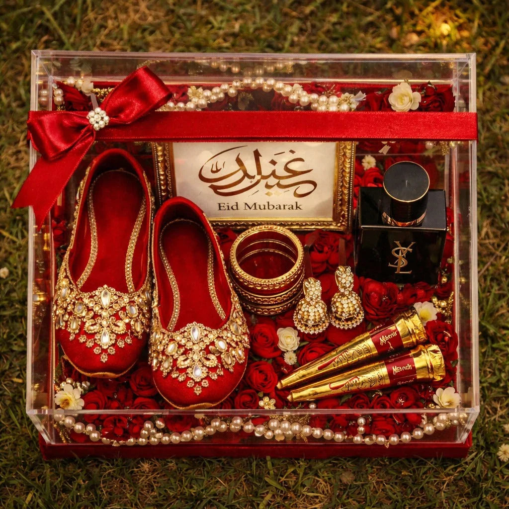 Eid Mubarak gift box with red embellished shoes, perfume, bangles, and roses for festive gifting