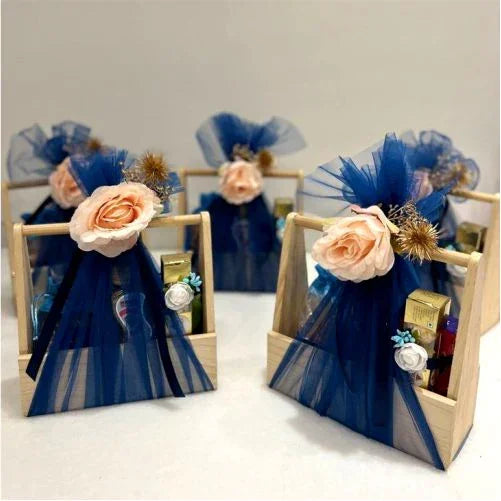 Elegant gift baskets with blue tulle, peach roses, and luxury items for special occasions