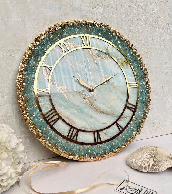 Elegant teal marble wall clock with gold Roman numerals and glittery frame, perfect for home decor