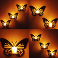 Butterfly wall decor with warm LED wall lights, elegant butterfly shaped wall lamps creating soft ambient lighting on textured wall.