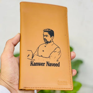 Custom picture wallet with photo and name engraving on tan leather, held in hand with a green plant in the background