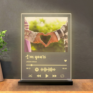 Spotify music night lamp with photo of couple making a heart, displaying "I’m Yours by Jason Mraz" with Spotify code, placed on a wooden table with a plant