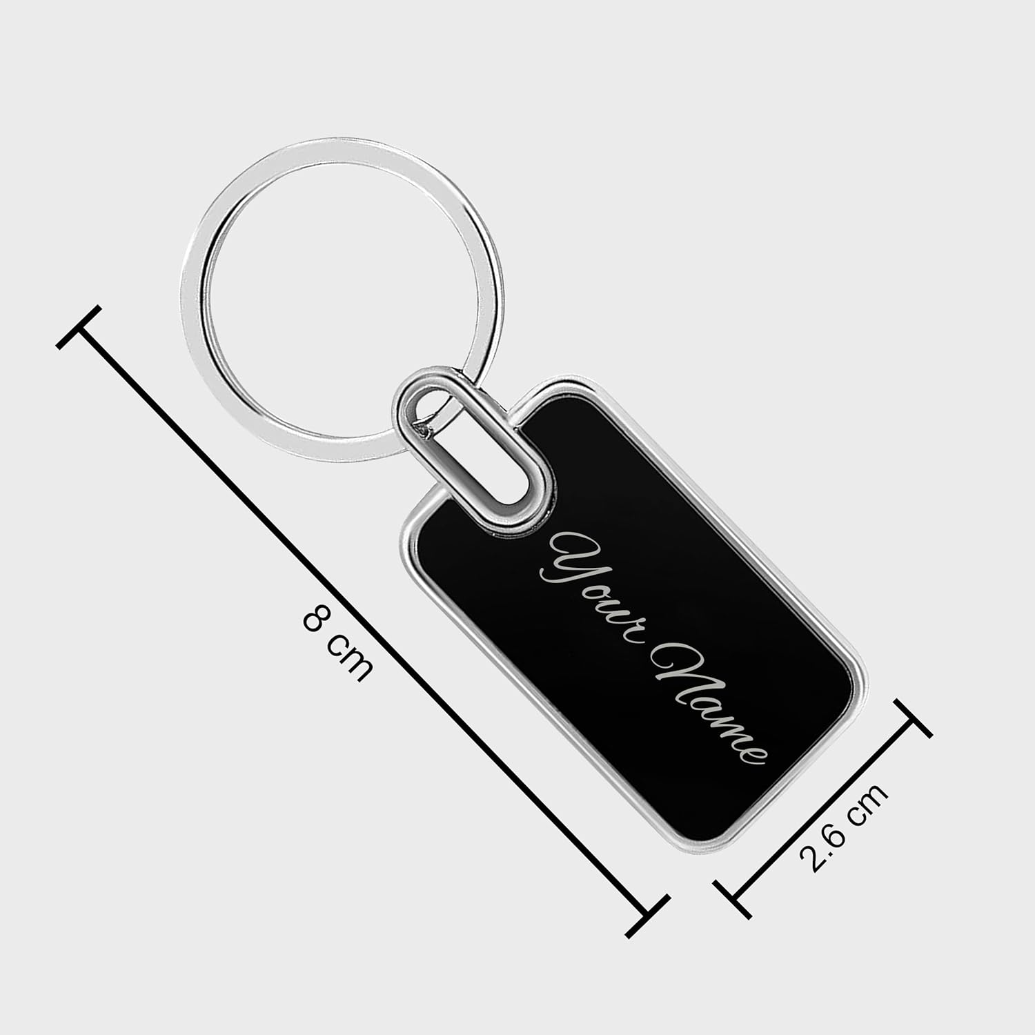Black and silver keychain with custom name engraving, measuring 8 cm in length and 2.6 cm in width.