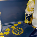 Customized Nikah velvet book kit with "Shaheer & Umaima" text, featuring gold heart accents and a decorative Nikkah pen with feathers, in a velvet box