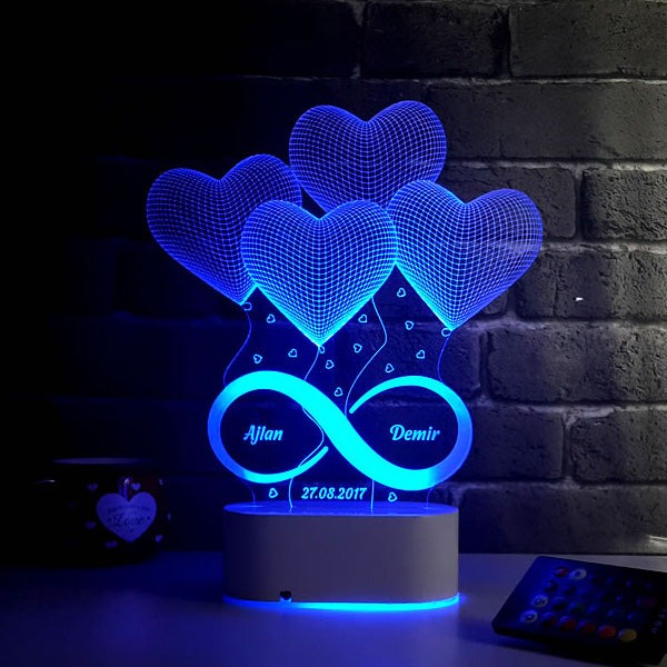 Eternal Love 3D LED night light with heart-shaped balloons and infinity design, displayed on a bedroom table with a mug