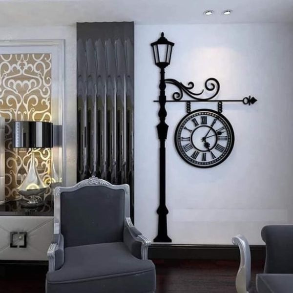 European Big wall clock with Roman numerals and ornate design, displayed on a living room wall with a chair and decor