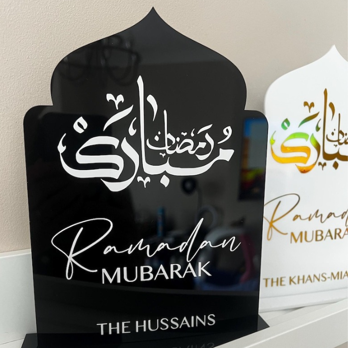 Personalized Ramadan Acrylic Sign with black background featuring Arabic calligraphy and "Ramadan Mubarak" in golden letters, customized with family name "The Hussains."