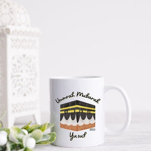  Personalized Umrah Mubarak mug with the Kaaba design and the name “Yusuf,” perfect for celebrating Umrah completion in 2023.