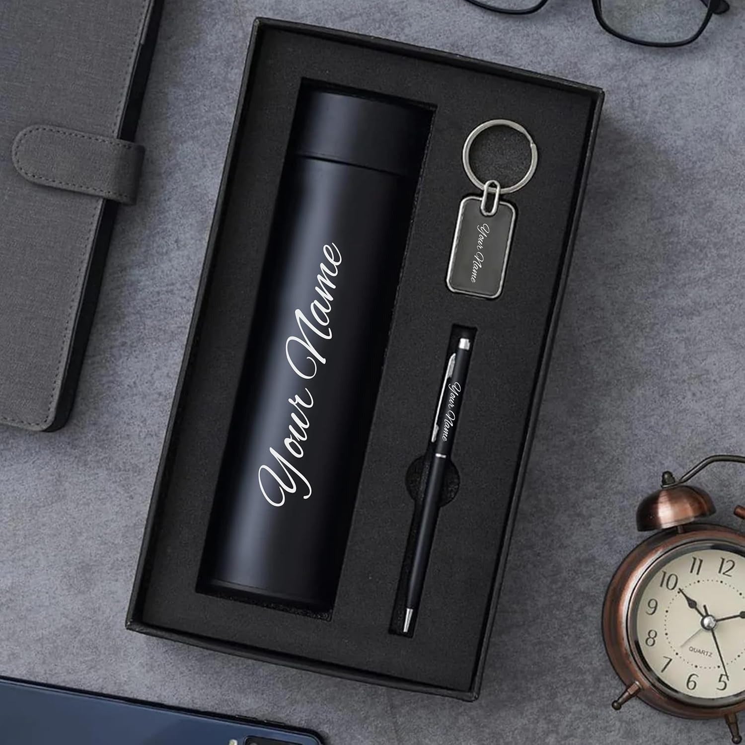Personalized gift set with black bottle, pen, and keychain in a premium box