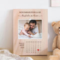  Personalized engraved wooden frame with a photo, calendar, and custom names, designed as a meaningful gift for a baptism or special occasion.