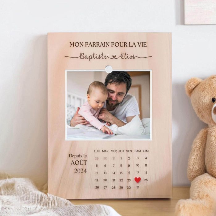  Personalized engraved wooden frame with a photo, calendar, and custom names, designed as a meaningful gift for a baptism or special occasion.