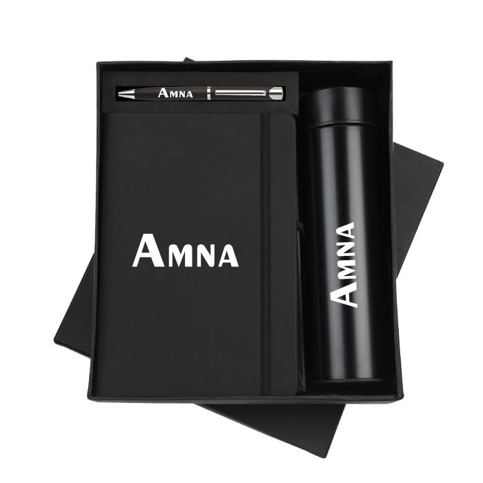 Personalized black gift set with custom-engraved notebook, pen, and thermos bottle in a premium gift box.