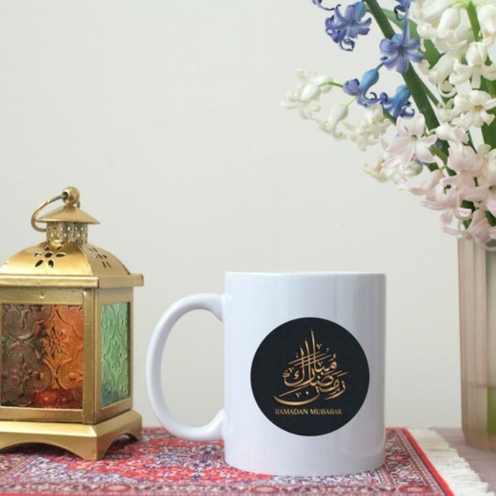 Ramadan Mubarak mug featuring elegant Arabic calligraphy on a white ceramic base, perfect for Ramadan tea or coffee.