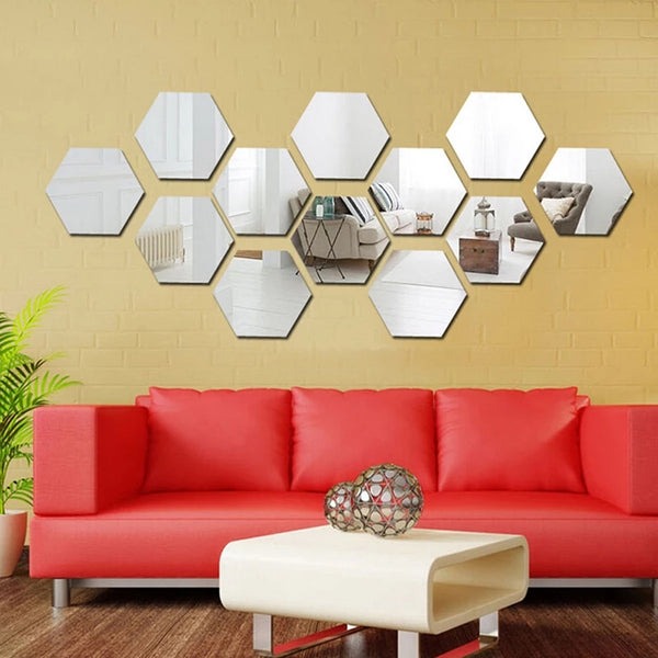 Silver acrylic hexagon wall decor mirror with a reflective finish, displayed on a minimalist living room wall with a white sofa