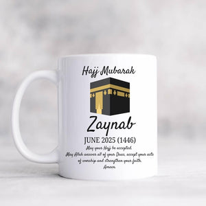White Hajj Mubarak mug with Kaaba illustration and custom name "Zaynab," featuring an Islamic dua for Hajj acceptance.