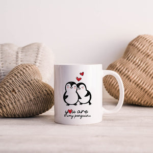 You Are My Penguin mug with cozy penguin design and hearts, displayed on a wooden table with decorative elements