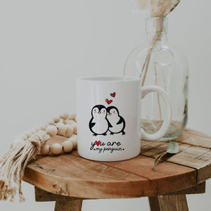 You Are My Penguin mug with cute romantic penguin design and hearts, displayed on a wooden table with decor