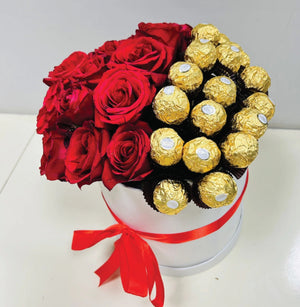Luxury white gift box with red roses and Ferrero Rocher chocolates, tied with a red satin ribbon, perfect for romantic gifting.