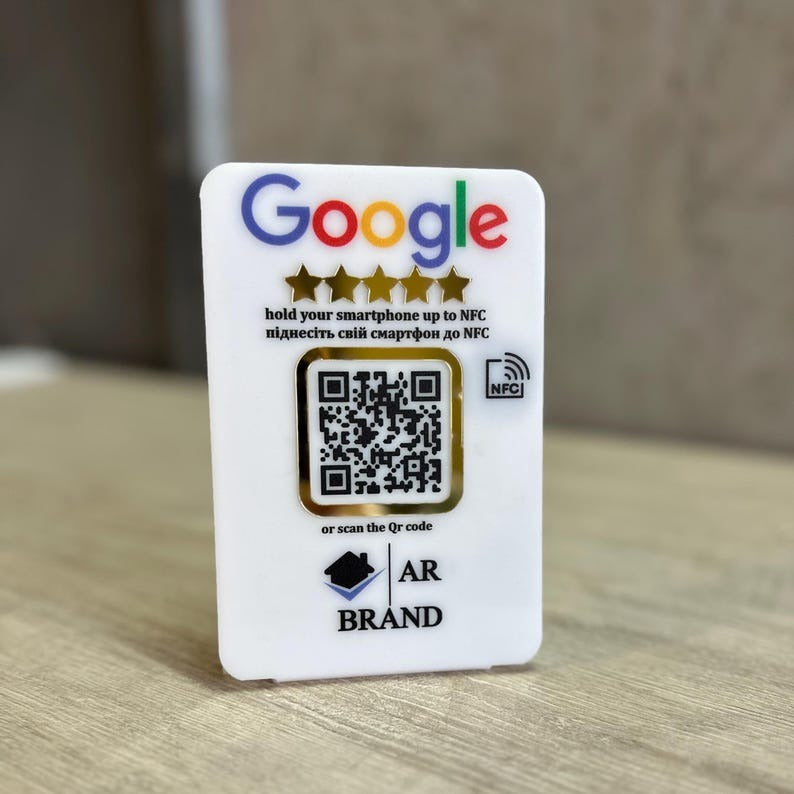  A sleek white acrylic Google Review NFC & QR Code Sign for businesses, featuring a scannable QR code and NFC tap functionality to leave instant reviews.